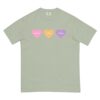 A light green Happily Ever After T-shirt featuring three heart shapes in pink, yellow, and lavender across the chest.