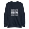 The Believe Unisex Sweatshirt features the word BELIEVE stacked vertically on the front, with alternating white and gray letters for a gradient effect.